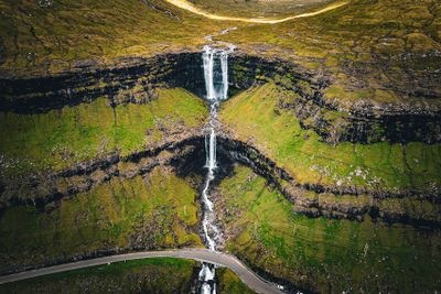 Foss, Streymoy  the best known Faroe Island waterfall.  Note vehicles on the road