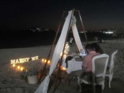 A proposal on the beach at night