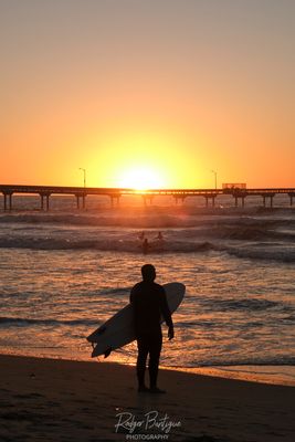 a surfer enjoying the sunset