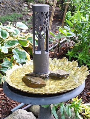 Birdbath with sculpture.