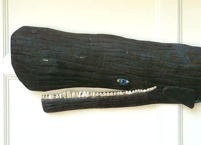 Wooden sperm whale hanging.