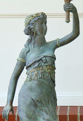 Woman with torch sculpture.