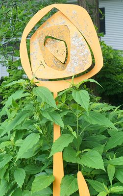 Yellow sculpture of a flower, by Tom Cowgill.
