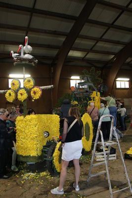 Every volunteer or visitor helps to decorate the floats that will parade the next day.