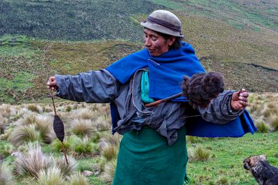 Quechua Shepherdess Spinning Llama Wool into Thread