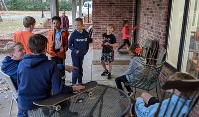 Kids on the patio: Caleb, Samuel, Luke, Joseph, Steve Burgess (background), Nathan, Max, Jocelyn, Ruthie and Pierce