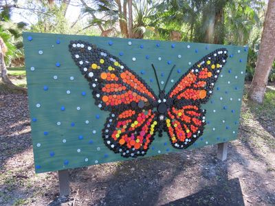 Butterfly made by gluing colored disks on a board