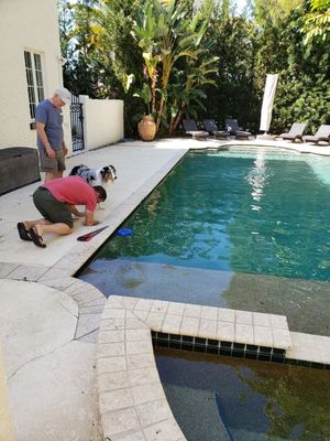 Jeremy cleaned the trap to the pool while Grandpa and Levi looked on helpfully.