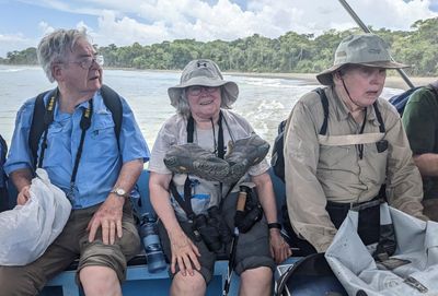 Jerry, Mary and Andy
The rough-water re-boarding wasn't the end of our adventure. Once we got out beyond the shore a ways, the pilots brought the two boats together and held them while we transferred from the 'borrowed' boat to ours. But the water was still a little too rough, so they separated the boats before everyone got transferred, went out a little farther, and finally got our whole group on our boat--we don't seem to have been wearing our life vests during the transfer either.