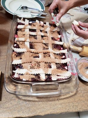 Angela puts the finishing touches on one of the cobblers before it goes in the oven.