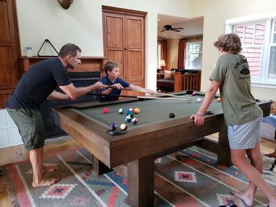 Jeremy helps Zane with a long shot while Pierce watches.