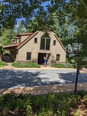 Looking from the drive, across the basketball court, to the bunkhouse
