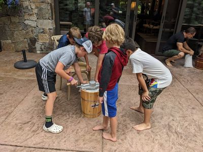 Max, Zane, Owen, Carson and Zeke work on the second freezer, while Jeremy adds ice to the first.
The mixer had a motor, but Jeremy and Seth decided it would be a good time to give the kids the experience of cranking an old-fashioned ice cream freezer, like they 'got to do' when they were kids.