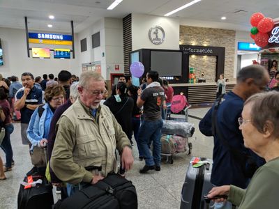 Mary, Ann, David Oakley, Dr Kannan and Carolyn, picking up our luggage early in the morning at the airport in Guayaquil, Ecuador, December 15, 2018.