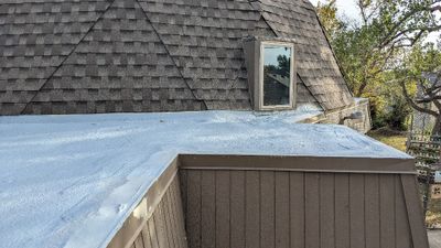 We went to Norman for lunch with friends and when we returned the crew had finished putting a new layer of foam over the flat roof. I got out the extension ladder and took some photos.