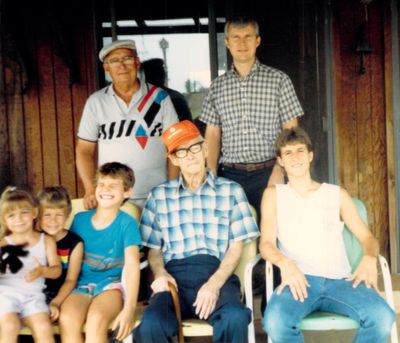 Sometime before 1996, back porch in Mustang: cousins Lisa and Daniel Sanders, Seth, Papa (Euritt James) Davis and Jeremy, with Grandad (Joseph Earl) Davis and Dad (Steven Perry Davis) standing behind