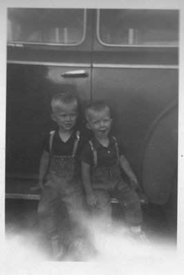 Steve and Gerald, sitting on the running board of an old car
