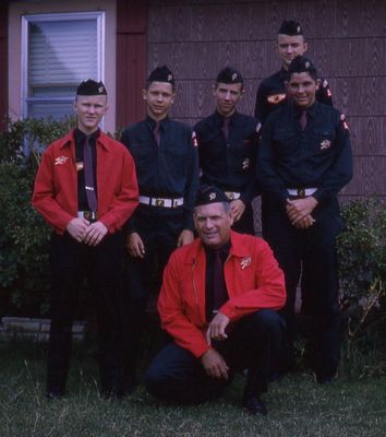 Steve (L), Gerald (on porch in back), Bob Kirby, scoutmaster (kneeling), and 3 other Explorer Scouts whose names I do not recall. Explorer Scouts were older than Boy Scouts. Haven't found any Boy Scout photos yet.