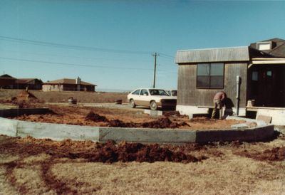 It was clear early on that we needed more space than the little dome and kitchen provided, but it took a few years before we got the courage to start a big addition. Mary wisely talked Steve into buying a kit with metal connectors and 2x6 struts--like a big tinker toy set--for the second, bigger dome. But first we had to have a stem wall and floor poured for what would eventually become the garage. We found a fellow named Herb Presley doing concrete work down the street. He assured us he could lay out the 15-sided base, and we took a leap of faith and hired him to do it. Unfortunately, at this point, we got lazy about taking photos, or we lost some, because we don't have much to else to show till the big dome was completed.