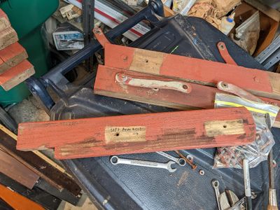 The metal braces are what the seat of the glider swings on.
