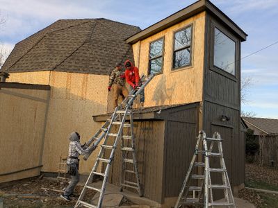 By the end of the first day, they had installed about a third of the siding, including some of the hard-to-reach second story panels on what we call our 'window room,' from which we watch birds in the back yard.