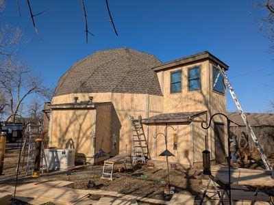 On Wednesday, Day 2, they finished installing a lot of the trim on the W and S sides, as well as caulking all the seams and nail holes.