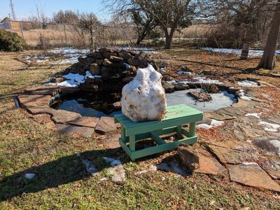 On Sunday morning, we looked out the back window to find the guys had left us a gift from the day before, a snowman sitting on the bench at the pond. Unfortunately, by the time I got to get its photo in the afternoon, it had lost a lot of weight.