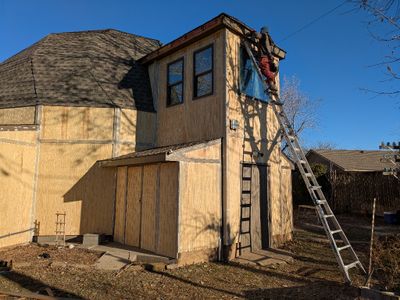 On Monday, they were back at work early. I had negotiated with Billy, the contractor, to take care of a couple of additional items his foreman Ricardo had recommended, replacing the fascia around two sides at the top of the window room, and replacing the soffit on the S side of our storm shelter.