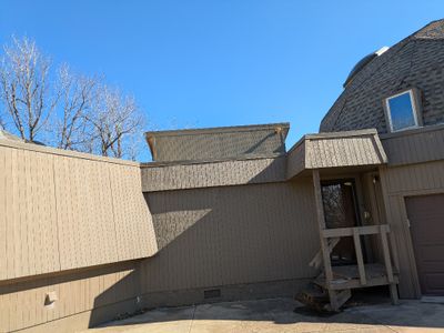 The W face of the sunroom wall, above the flat roof