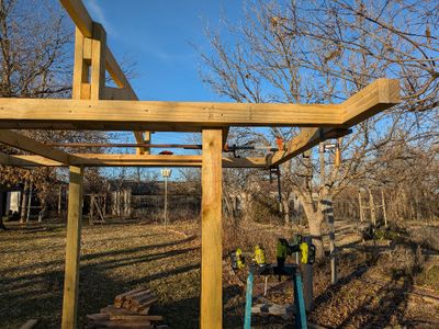 The outer support on the E side was very warped--bowed out--so I used a couple of Dad's old pipe clamps to pull it straight before attaching the second board to it. I'm leaving the clamps on till I get the rafters and decking attached, to ensure they stay in line.