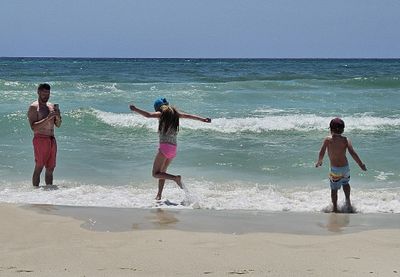 Saturday was another day at the beach. Mary caught Bryce taking photos of Alexa and Xander playing in the surf.