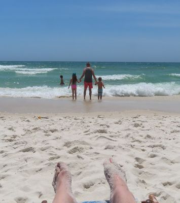 Mary got some photos over her sandy toes while she relaxed under an umbrella.