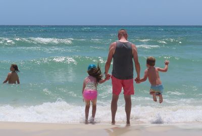 Max, Alexa, Bryce and Xander, playing in the surf