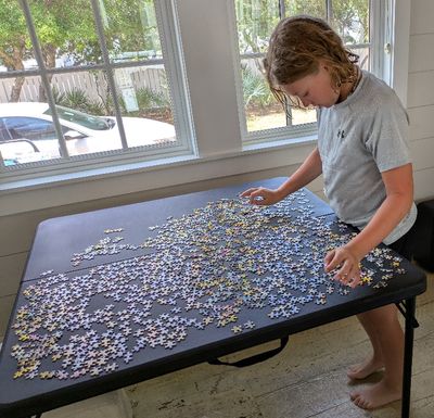 Max takes a stab at the last jigsaw puzzle.