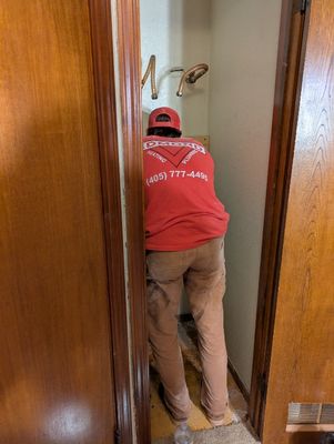 Christian installed 2x4 boards on the back wall of our water heater closet to mount the new heater.