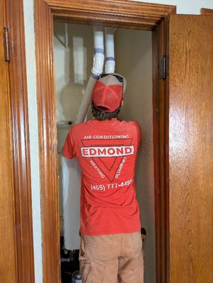 Christian, making final adjustments to vent pipes going into the ceiling