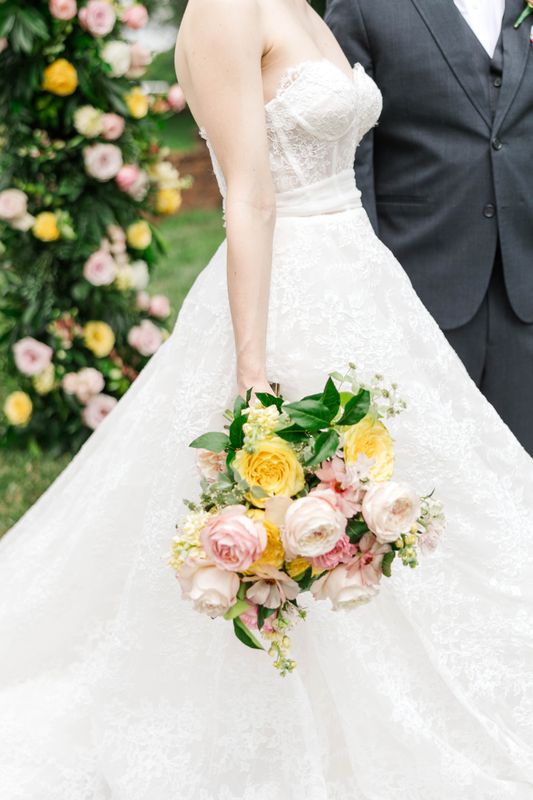 Bridal bouquet in bright summer colors being held by Bride 