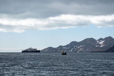 Ship and Zodiac In the Harbour