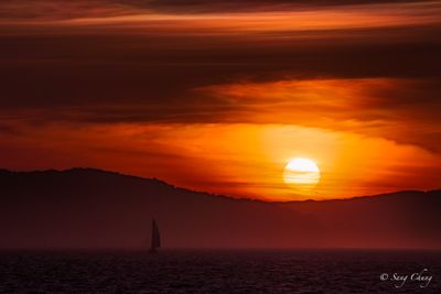 the sun and sail boat at just before evening
