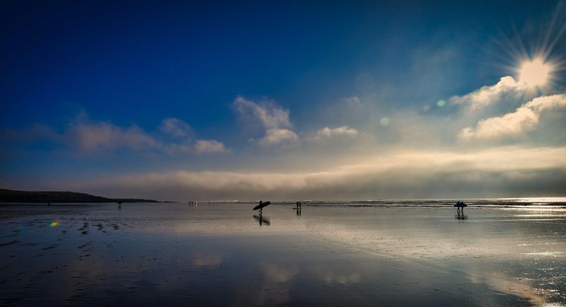 Surfers and fog bank at Rest Bay.