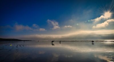 Surfers and fog bank at Rest Bay.