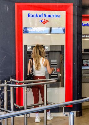 Boston Massachusetts fan withdrawals cash from a Bank of America ATM