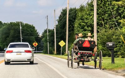 Amish buggy driving on the side of the road in Pennsylvania