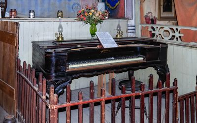 Rosewood Grand Piano, here since its arrival in 1881, at the Bird Cage Theater in Tombstone AZ