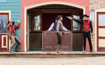 Doc Holiday holds a gun on the Clanton brothers at the Gunfight at the OK Corral