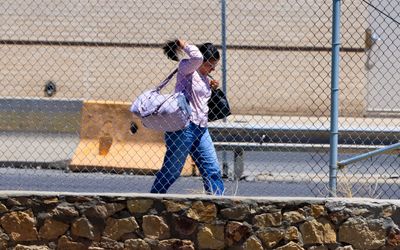 A woman walks towards Mexico through the US Port of Entry in Chamizal National Memorial