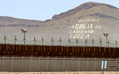 Mountain sized advertisement over the border wall in Chamizal National Memorial