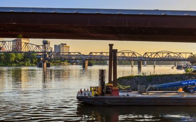 Sunset view under I-30 looking at downtown and the Main Street and Broadway Street bridges in Little Rock