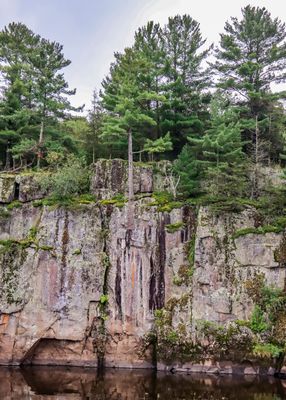 Trees on the edge of the towering cliffs along the St. Croix River in St. Croix NSR