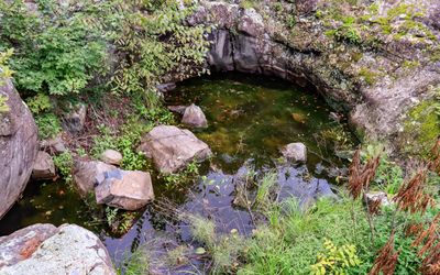 Caldron Pothole, filled with boulders, along the Glacial Potholes Trail in Interstate State Park
